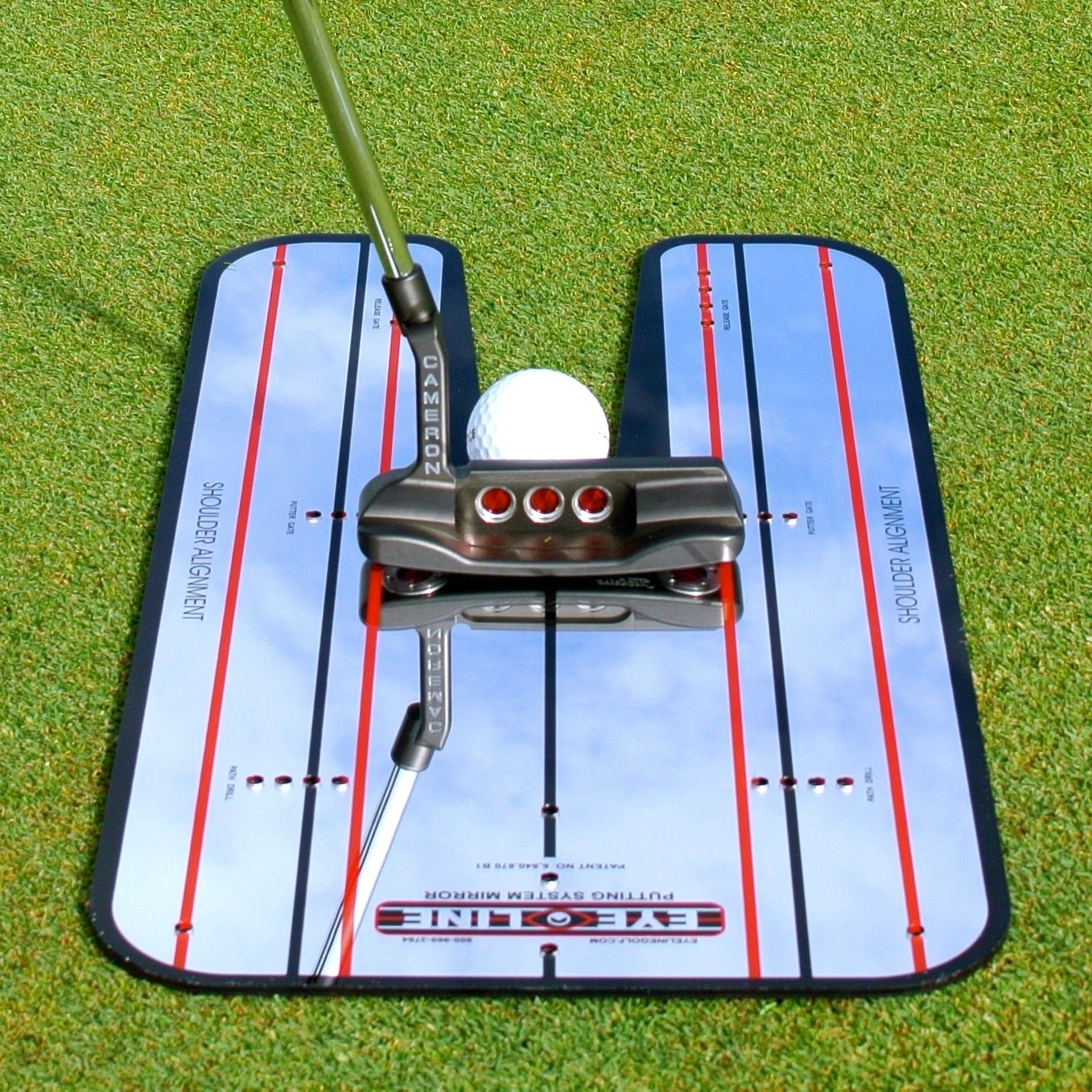 A putter and golf ball on a Classic EyeLine Putting Mirror with printed alignment lines.