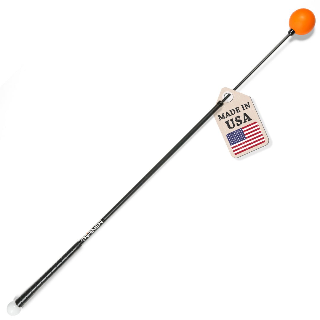 A full-length Orange Whip Trainer with a black flexible shaft, orange weighted ball and white counterweight.