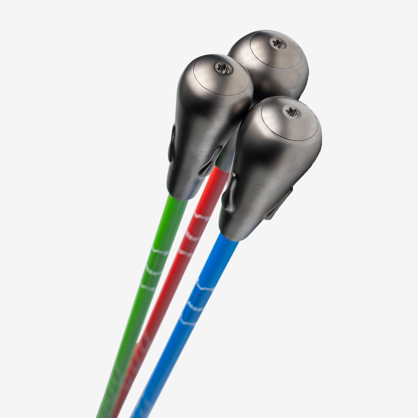 Three SuperSpeed Golf Speed Sticks Pro with green, red and blue shafts and dark weighted heads.